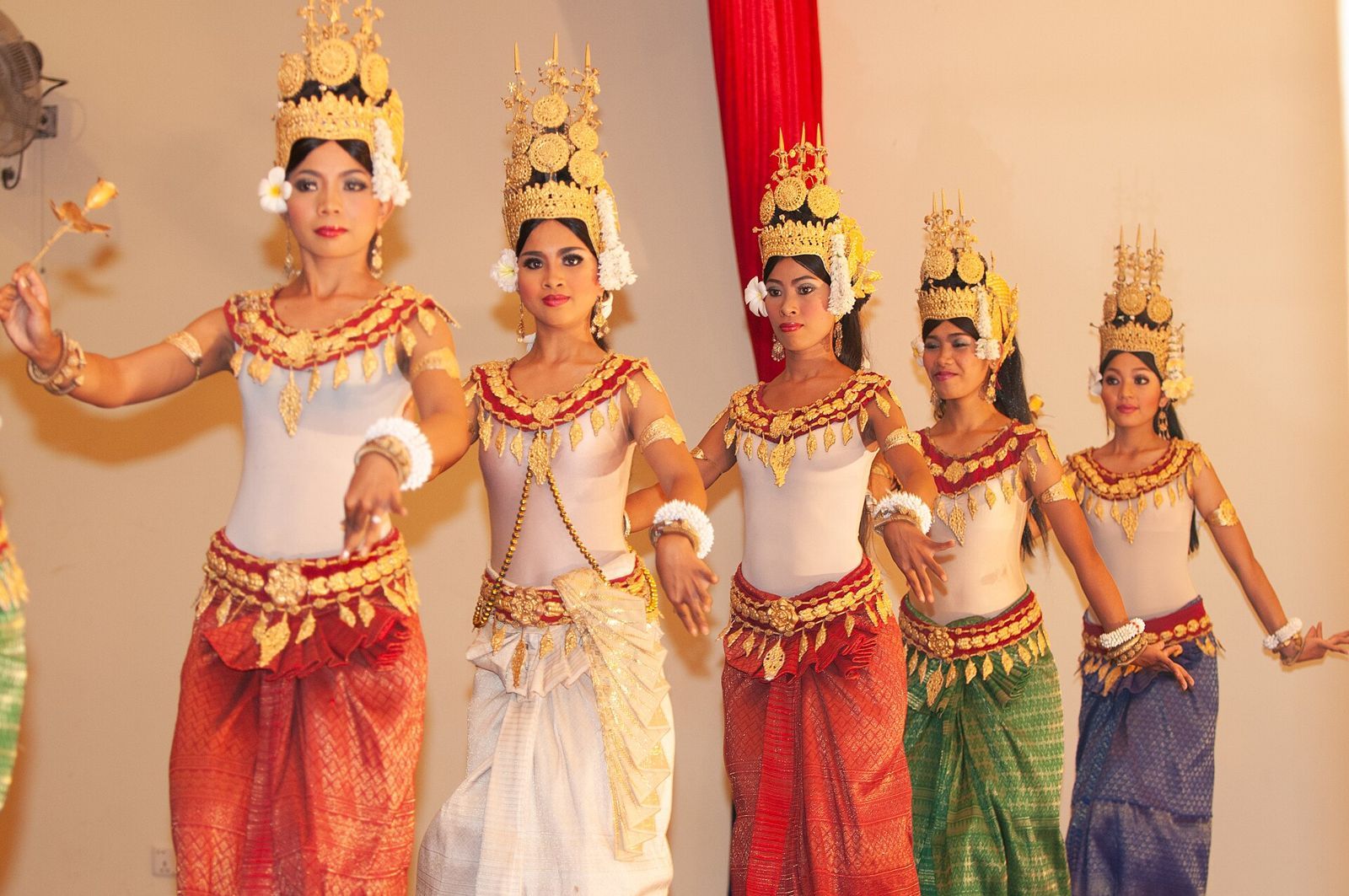 Featured Apsara dancer accompanied by younger supporting performers during a cultural presentation in Siem Reap, Cambodia.
Not photographed inside a temple.

Photographed in late 2009. EXIF timestamp 